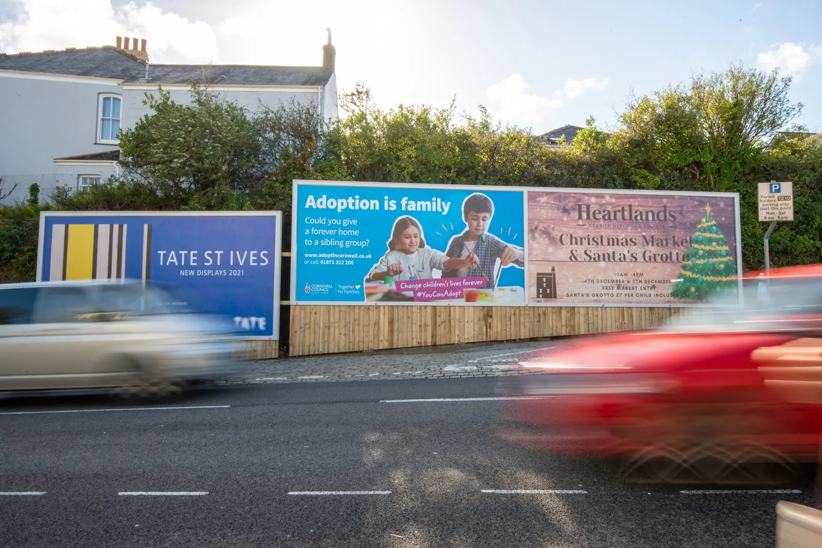 The Richmond Hill billboards in Truro with traffic blurring past